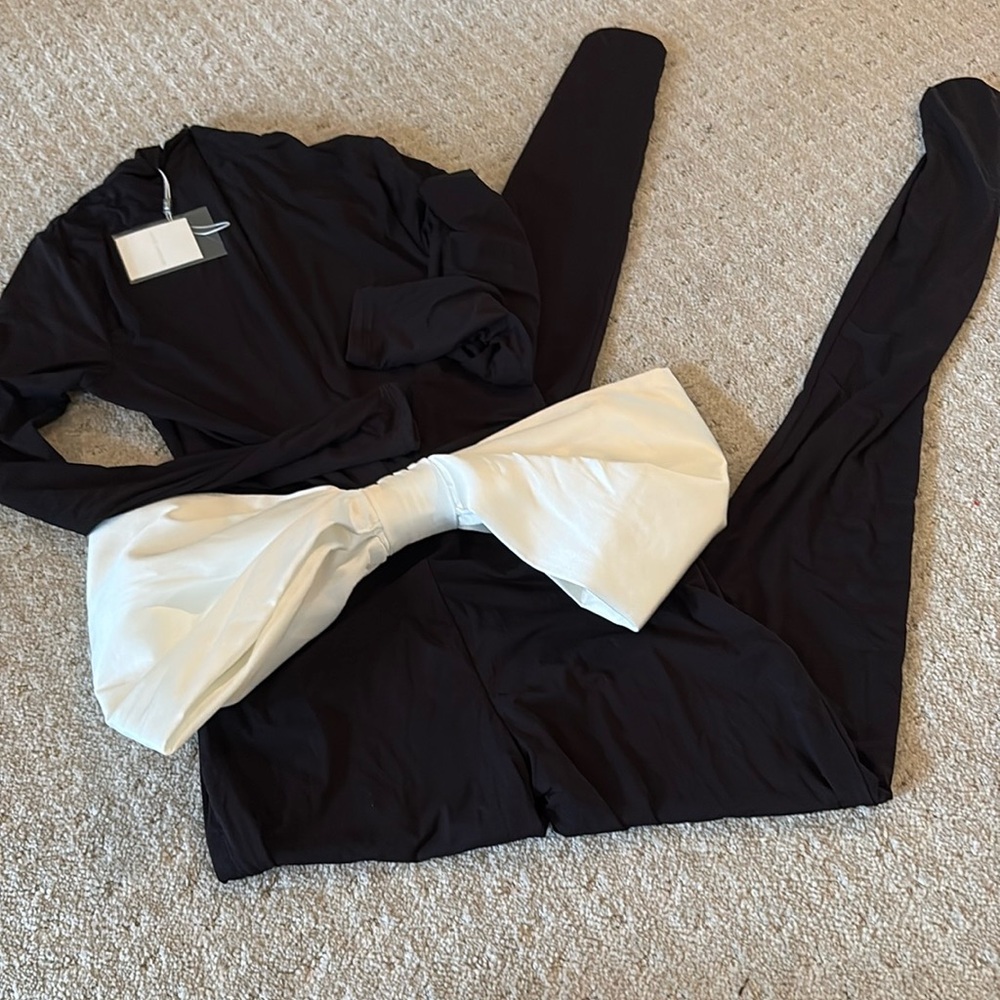 Naked Wardrobe long sleeve turtle neck jumpsuit with large bow on back NWT